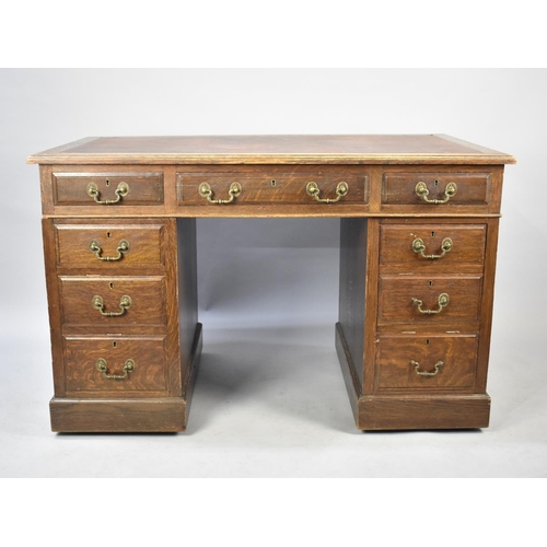 498 - An Edwardian Oak Kneehole Desk with Iset Writing Surface, 122cm wide