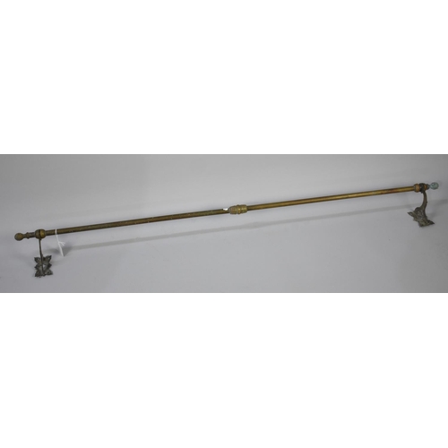 499 - A Late Victorian Brass Door Curtain Pole complete with original mounting Brackets, 132cm wide