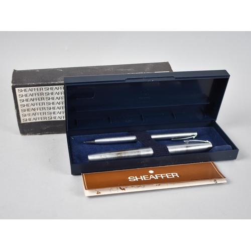 54 - A Cased Parker Ink Pen and a Sheaffer Stainless Steel Pen and Pencil Set