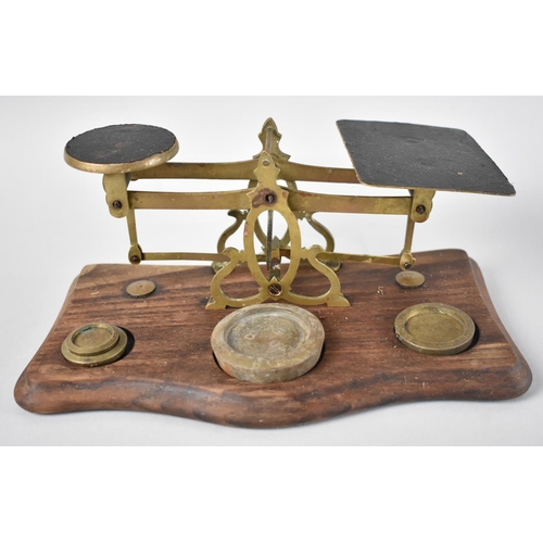 61 - An Edwardian set of Brass Postal Scales with Unrelated Weights on Wooden Plinth Base, 24cm Wide