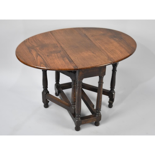 67 - A Small Oak Drop Leaf Gate Leg Occasional or Coffee Table with Oval Top, 56cm Long 51cm High