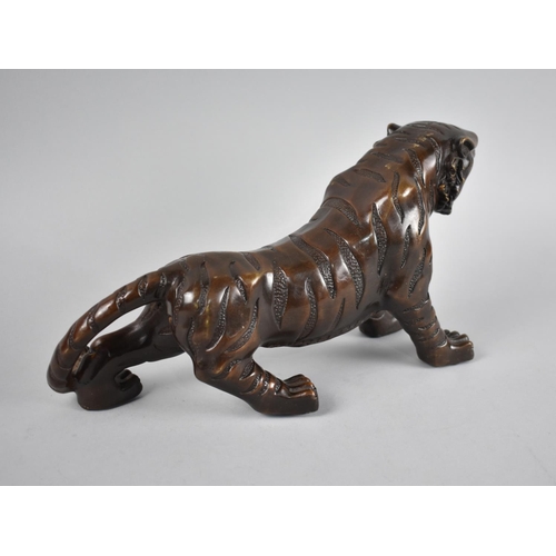 72 - A Large and Heavy Patinated Bronze Study of a Tiger, 35cm Long