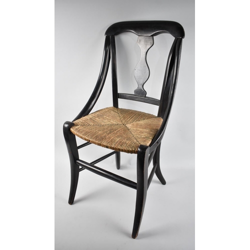 104 - An Edwardian Ebonised Rush Seated Childs Chair