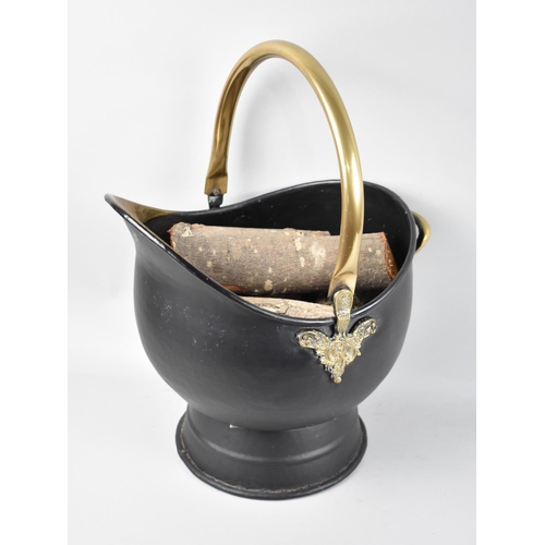 109 - A Reproduction Brass Mounted Helmet Shaped Coal Scuttle containing Logs