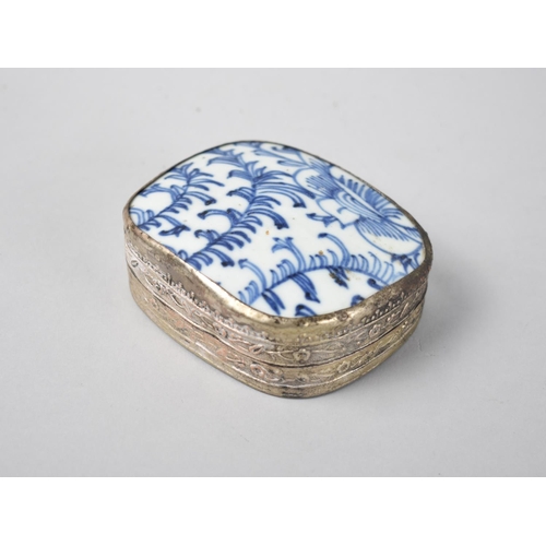 13 - A Chinese White Metal Rectangular Box with Blue and White Porcelain Lid, 9cms by 7cms