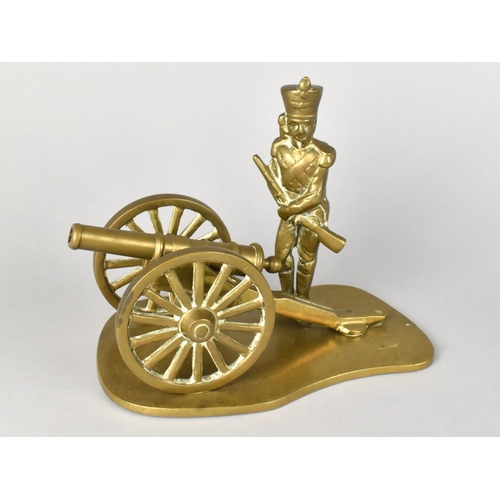 30 - A Brass Ornament of Soldier Standing Beside Field Cannon, 19cms Long