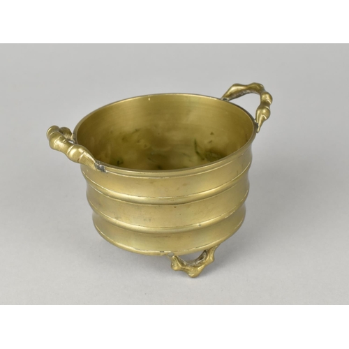 37 - An Oriental Bronze Two Handled Circular Pot with Three Feet, 7.5cms Diameter