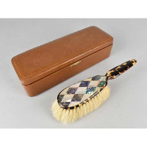 4 - An Edwardian Leather Cased Tortoiseshell, Mother of Pearl and Paua Shell Clothes Brush, 17.5cms Long... 