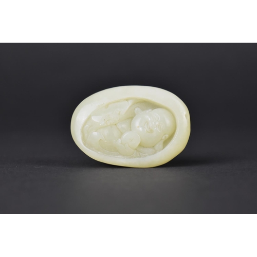 49 - An Oval Carved Jade Pebble Study of The Buddhai, 5cms High