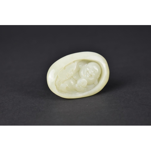 49 - An Oval Carved Jade Pebble Study of The Buddhai, 5cms High