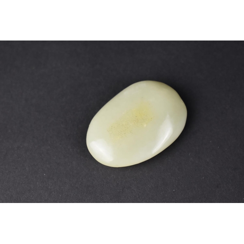 49 - An Oval Carved Jade Pebble Study of The Buddhai, 5cms High