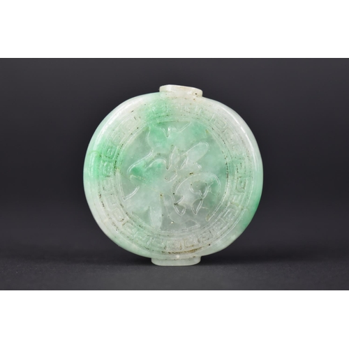 50 - A Chinese Jade Effect Snuff Bottle with carved Decoration, 5cms Diameter