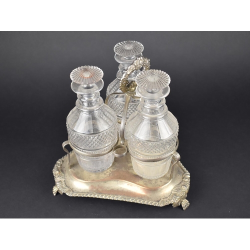 58 - A Georgian Style Three Bottle Tantalus on Silver Plated Stand, Glass Bottles of Mallet Form having C... 