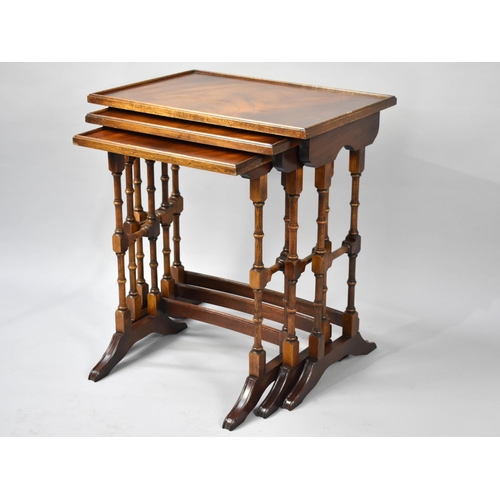 75 - A Reproduction Walnut Nest of Three Tables with Spindle Supports, 50cms Wide