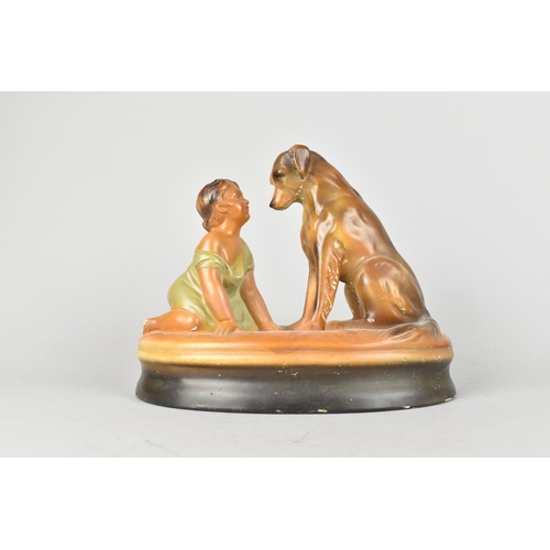 81 - An Early 20th Century Cold Painted Plaster Figure Group of Seated Dog and Young Child, 23cms Long