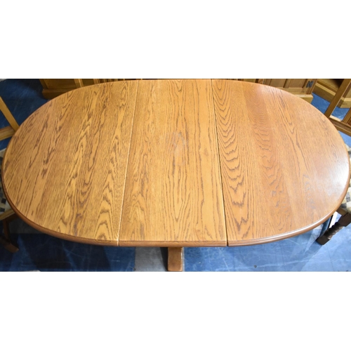 482 - A Late 20th Century Oak Old Charm Drop Leaf Dining Table together with Six Old Charm Gothic Revival ... 