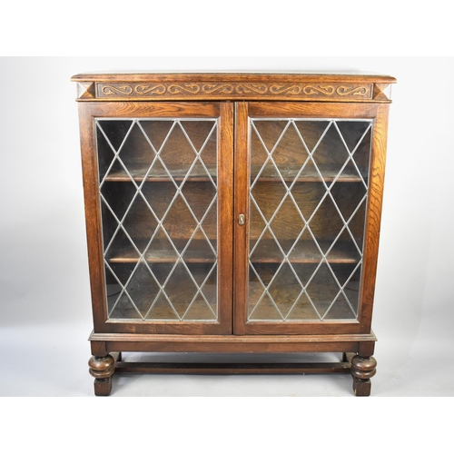 486 - A Mid 20th Century Oak Bookcase with Leaded Glazed Panelled Doors, 102cms Wide