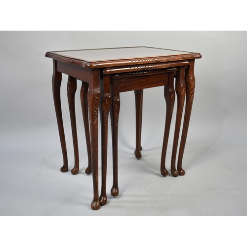 525 - A Nest of Three Mahogany Framed Tables with Tooled Leather Tops