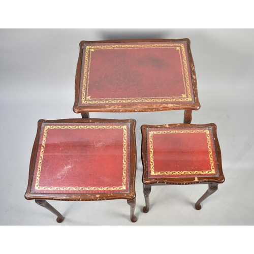 525 - A Nest of Three Mahogany Framed Tables with Tooled Leather Tops