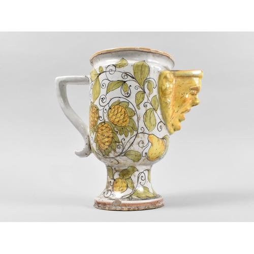 62 - A Continental Faience Mask Head Jug Decorated with Hops, 23.5cms High