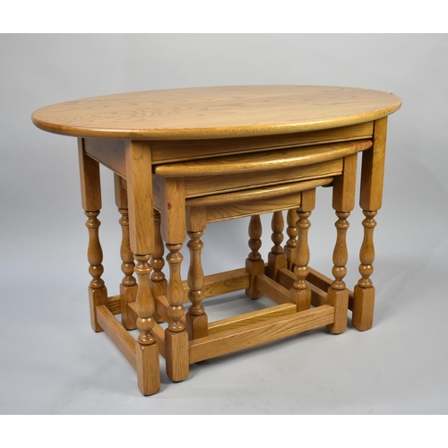 84 - A Modern Nest of Three Oval Topped Oak Tables, 82cms Wide