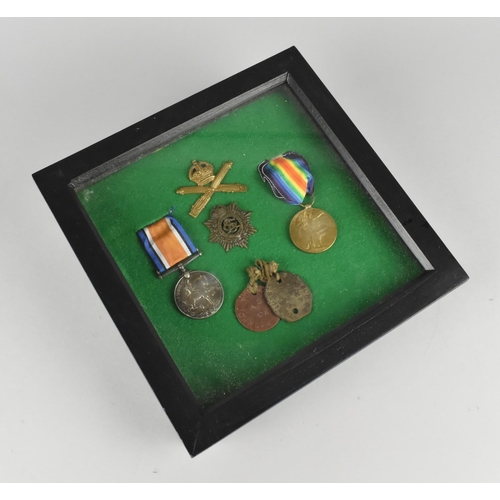 123 - A Framed Collection of Military Badges, Dog Tags and WWI Medals Awarded to 102398 Pte GA Johnson