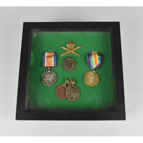 123 - A Framed Collection of Military Badges, Dog Tags and WWI Medals Awarded to 102398 Pte GA Johnson