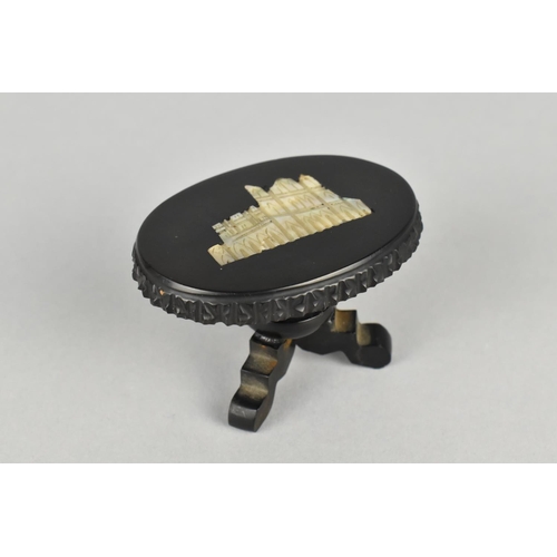 14 - A Whitby Jet Souvenir Model of a Oval Topped Tripod Table with Mother of Pearl Inlay, 5.25cm Long