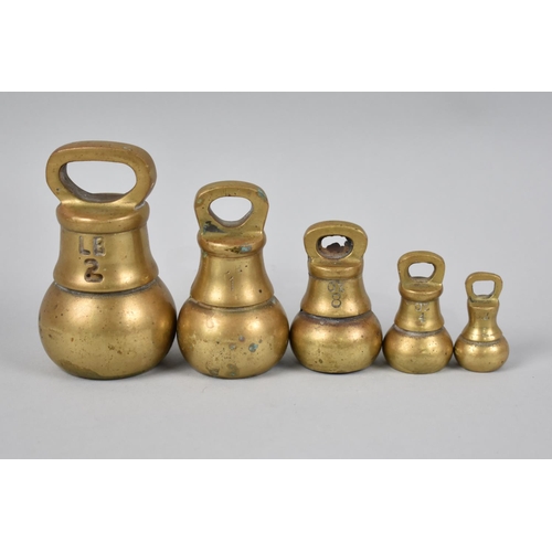 27 - A Set of Five Brass Bell Weights, The Heaviest 2lbs