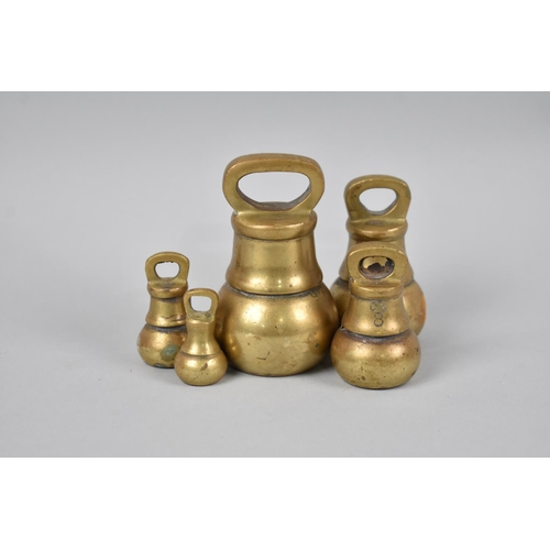 27 - A Set of Five Brass Bell Weights, The Heaviest 2lbs