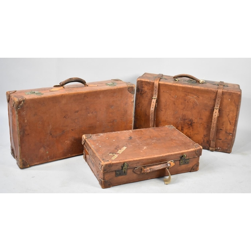 495 - A Collection of Three Vintage Graduated Leather Suitcases, Largest 76cm wide