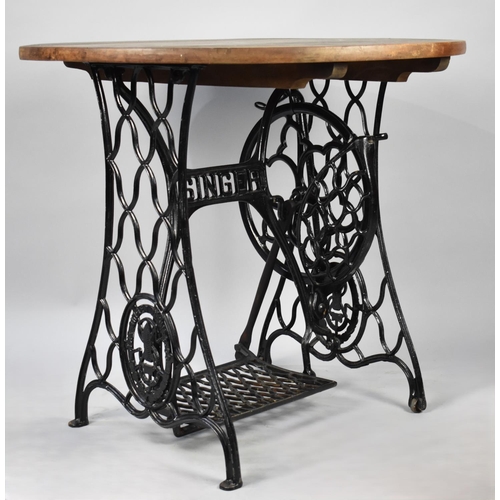 520 - A Circular Topped Table, the Base Formed from a Singer Treadle Sewing Machine, 82cm diameter