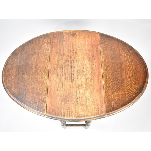 105 - A Mid 20th Century Oak Oval Topped Drop Leaf Barley Twist Occasional Table, 60cms Wide