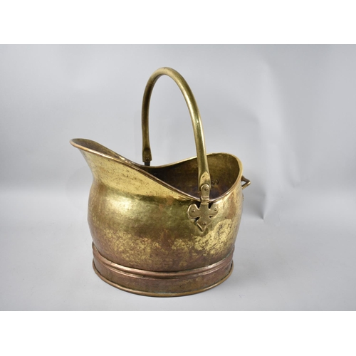 130 - A Mid 20th century Brass Helmet Shaped Coal Scuttle with Loop Handle, 40cms Long