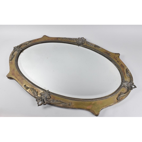 80 - An Oxidised Brass Oval Wall Mirror with Fleur De Lys Mounts, 88cms by 60cms, Bevelled Glass