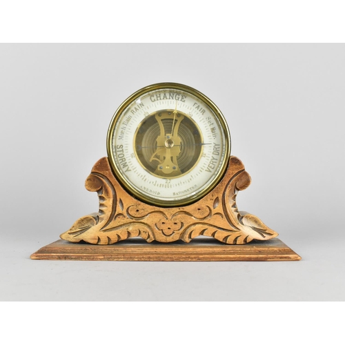 20 - A Late 19th Century Brass Circular Aneroid Barometer Mounted on Carved Wooden Stand, 21.5cms Wide