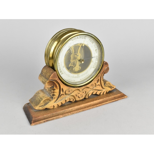 20 - A Late 19th Century Brass Circular Aneroid Barometer Mounted on Carved Wooden Stand, 21.5cms Wide