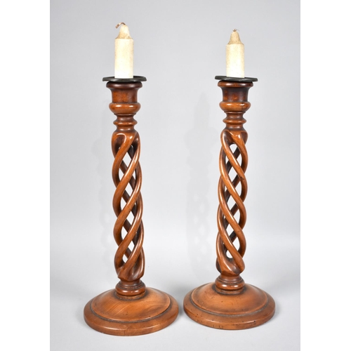 40 - A Pair of Edwardian Turned Fruitwood Open Spiralled Candlesticks with Metal Drip Trays, 34cms High