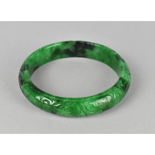 435 - A Carved Jade Effect Bangle, 7.5cm Diameter