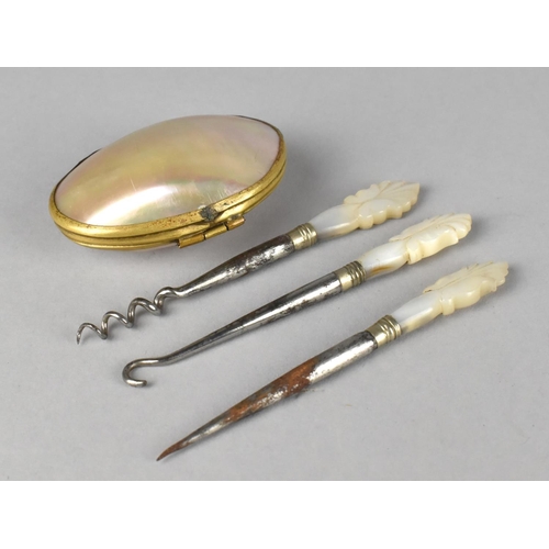 45 - A Mother of Pearl Purse in the Form of a Shell together with Mother of Pearl handled Manicure Tools