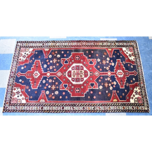 496 - A Patterned Woollen Rug, 217x121cms