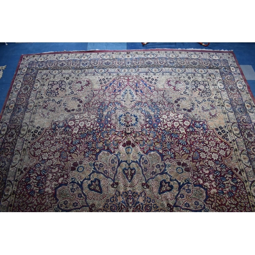 500 - A Large Patterned Woollen Rug, 460x314cms