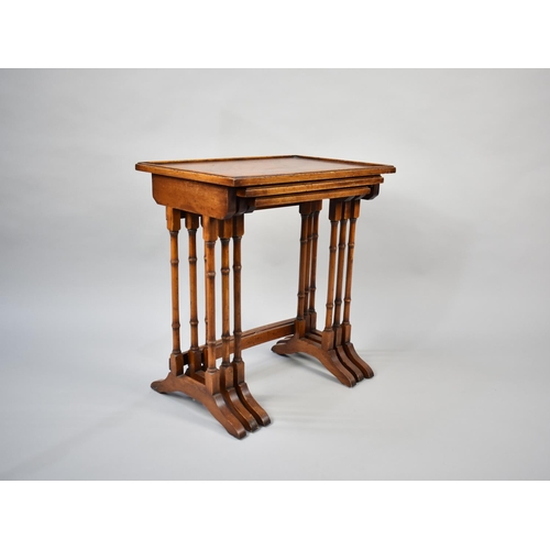 58 - A Late 20th Century Nest of Three Crossbanded Mahogany Tables with Spindle Supports, 54cms Wide