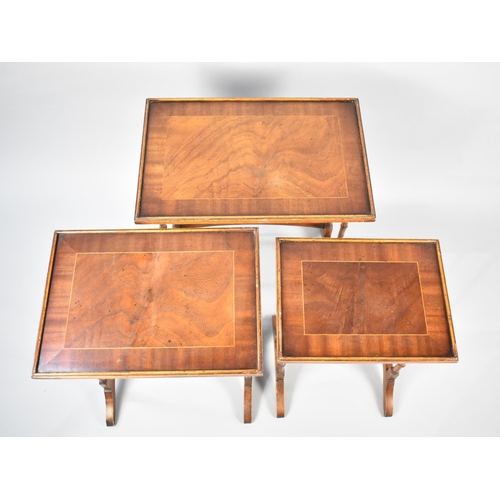 58 - A Late 20th Century Nest of Three Crossbanded Mahogany Tables with Spindle Supports, 54cms Wide