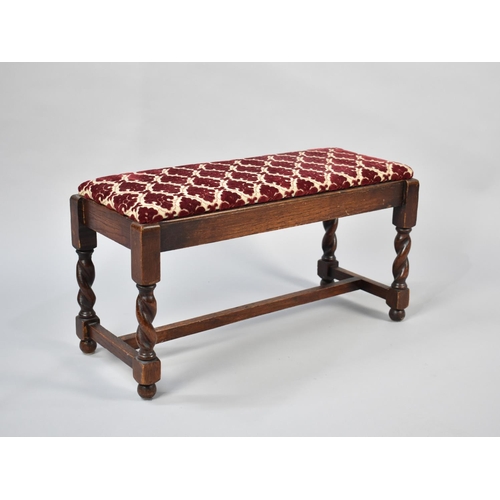 77 - A Mid 20th Century Oak Framed Foot Stool with Barley Twist Supports and Cut Velvet Pad, 62cms Wide