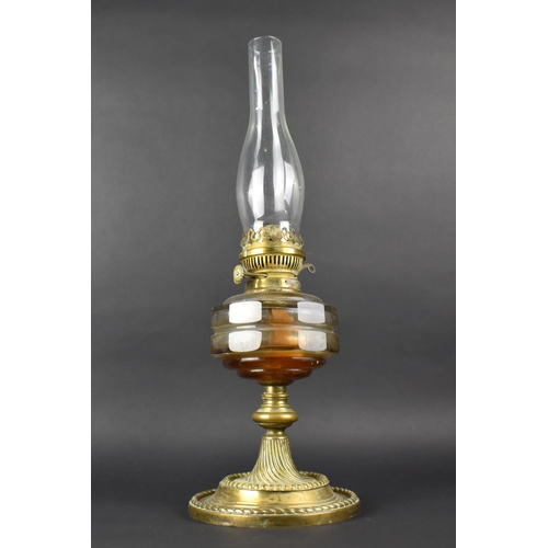 125 - A Late Victorian Brass Based Oil Lamp with Plain Glass Reservoir and Chimney, 55cms High