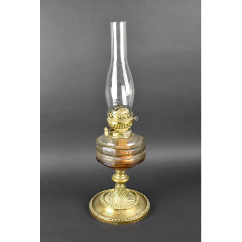 125 - A Late Victorian Brass Based Oil Lamp with Plain Glass Reservoir and Chimney, 55cms High