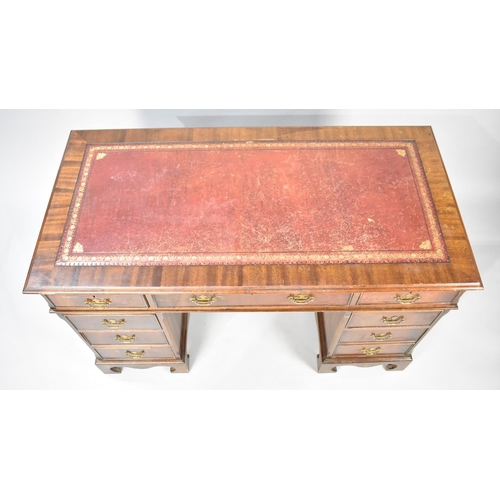 142 - A Mid 20th Century Mahogany Kneehole Writing Desk with Tooled Leather Top, 121cms Wide