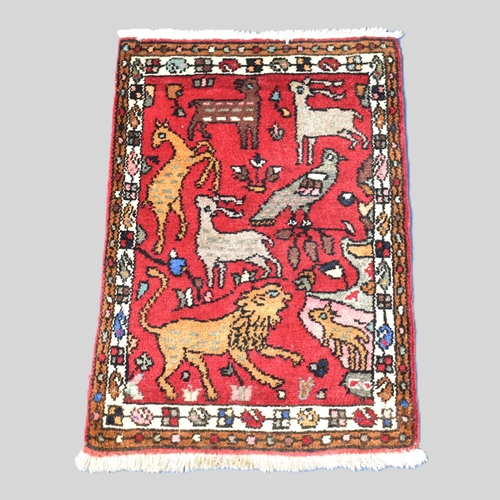 545 - A Small Patterned Hearth Rug Depicting Animals and Birds, 85x60cms