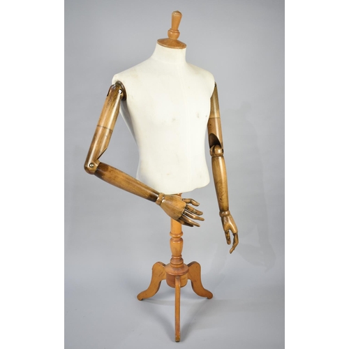 109 - A Dress Makers Dummy with Articulated Wooden Arms on Tripod Stand